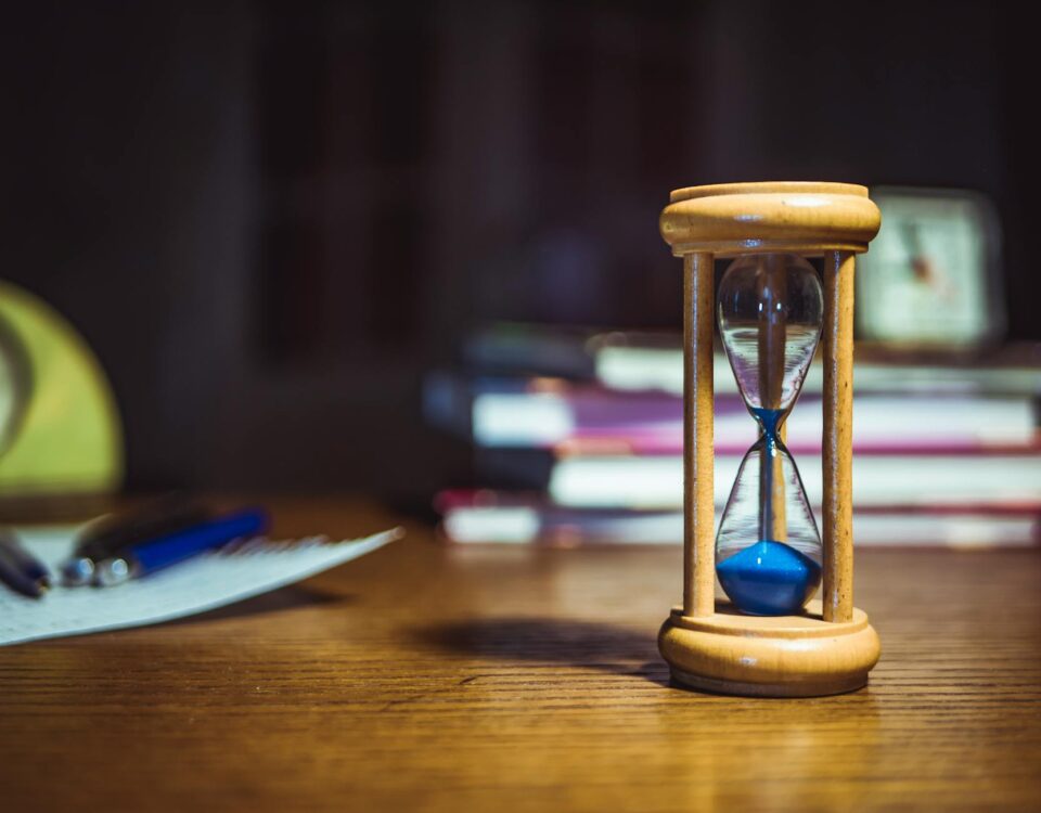 hourglass on brown wooden frame